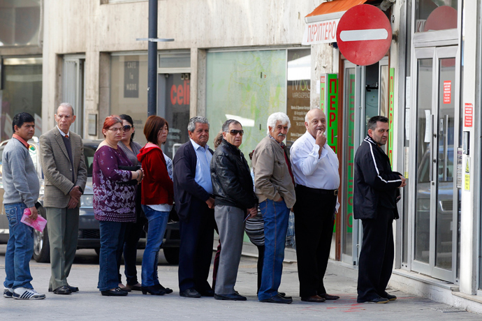 Depositors wait for the opening of a branch of Laiki Bank in Nicosia (Reuters / Bogdan Cristel)