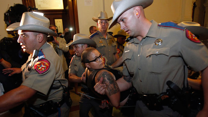 Police carry an abortion rights protester down the stairs of the State Capitol after the state Senate passed legislation restricting abortion rights in Austin, Texas early July 13, 2013.(Reuters / Mike Stone)