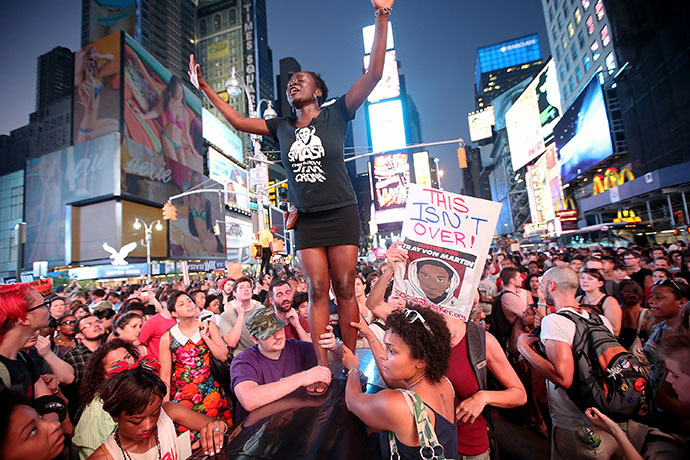 Trayvon Martin supporters rally in Times Square while blocking traffic after marching from a rally for Martin in Union Square in Manhattan on July 14, 2013 in New York City. (AFP Photo / Mario Tama)