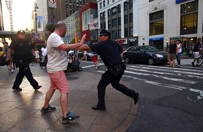 A police officer prevents a man from marching to Times Square during a rally in reaction to the acquittal of George Zimmerman in New York July 14, 2013. (Reuters / Eric Thayer)