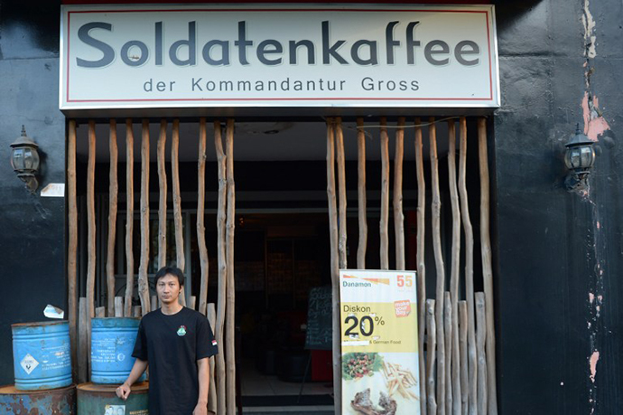 Owner Henry Mulyana standing outside the Soldatenkaffe "The Soldiers' Cafe" in Bandung. (AFP Photo / Adek Berry)