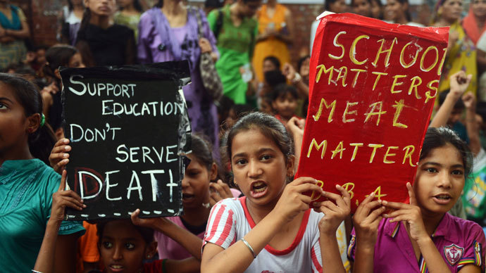 Indian children and activists shout anti-government slogans as they march to parliament demonstrating against the death of 23 children in Bihar state after they ate poisoned 'midday meals' during a protest in New Delhi on July 20, 2013.(AFP Photo / Raveendran)