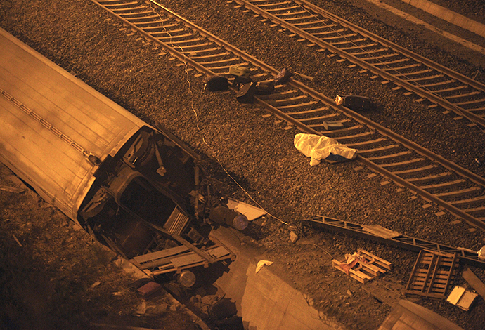 A picture taken on July 24, 2013 shows a derailed car at the site of a train accident near the city of Santiago de Compostela. (AFP Photo / Miguel Riopa)