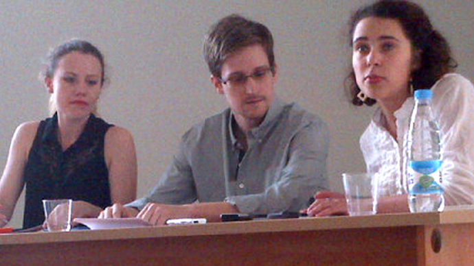 US National Security Agency (NSA) fugitive leaker Edward Snowden (C) during a meeting with rights activists, with among them Sarah Harrison of WikiLeaks (L), at Moscow's Sheremetyevo airport, on July 12, 2013 (Tanya Lokshina / Human Rights Watch). Video courtesy: Rossiya 24 TV channel