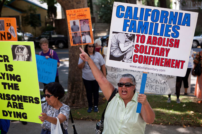 Christina Reyes holds a banner as she protests against indefinite solitary confinement in California prisons, outside the California Department of Corrections and Rehabilitation office in Sacramento, California July 30, 2013. (Reuters / Max Whittaker)
