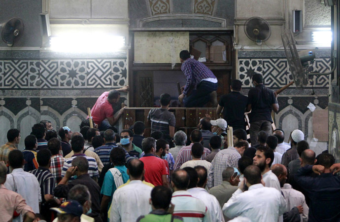 Demonstrators in support of ousted Egyptian President Mohamed Mursi wait by the barricaded door inside al-Fath mosque at Ramses Square in Cairo August 17, 2013. (Reuters/Mohamed Abd El Ghany)