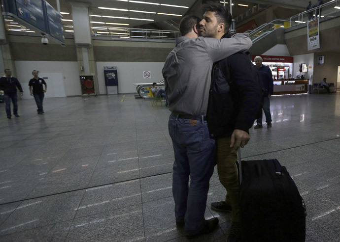 U.S. journalist Glenn Greenwald (front L) embraces his partner David Miranda upon his arrival at Rio de Janeiro's International Airport August 19, 2013. (Reuters/Ricardo Moraes)