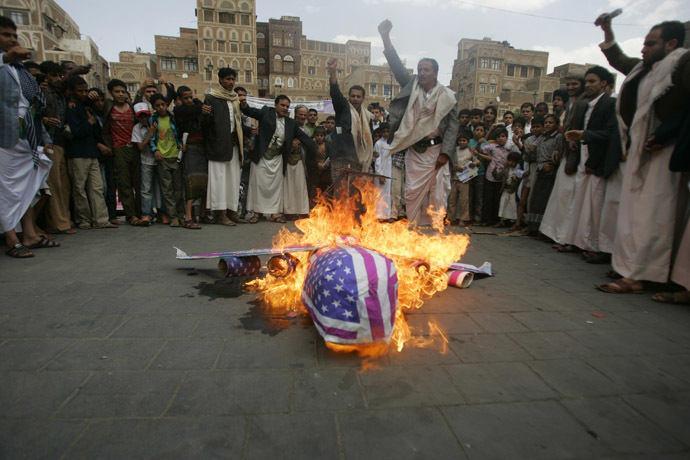 Protesters loyal to the Shi'ite al-Houthi rebel group burn an effigy of a U.S. aircraft during a demonstration to protest against what they say is U.S. interference in Yemen, including drone strikes, after their weekly Friday prayers in the Old Sanaa city April 12, 2013. (Reuters/Khaled Abdullah)