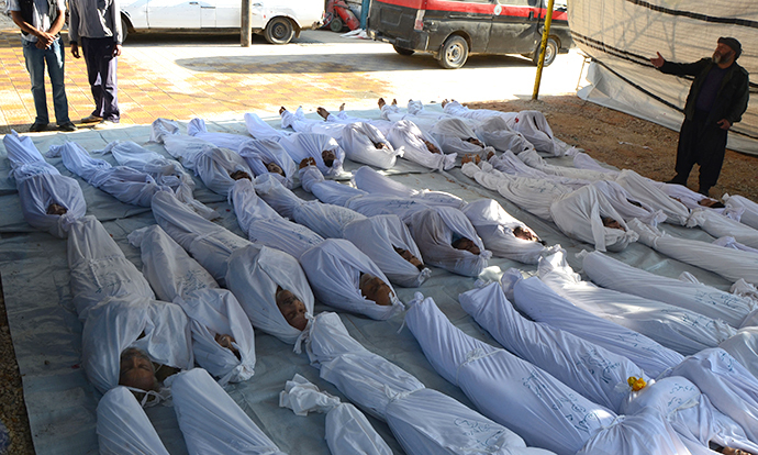 Syrian activists inspect the bodies of people they say were killed by nerve gas in the Ghouta region, in the Duma neighbourhood of Damascus August 21, 2013. (Reuters)