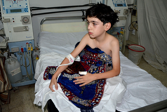 A boy, affected by what activists say is nerve gas, is treated at a hospital in the Duma neighbourhood of Damascus August 21, 2013. (Reuters)