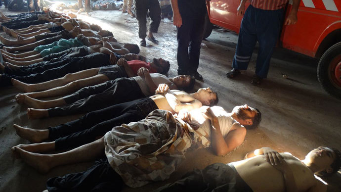 A handout image released by the Syrian opposition's Shaam News Network shows bodies of boys and men lined up on the ground in the eastern Ghouta suburb of Damascus, whom the Syrian opposition said on August 21, 2013 were killed in a toxic gas attack by pro-government forces.(AFP Photo / Shaam News Network)