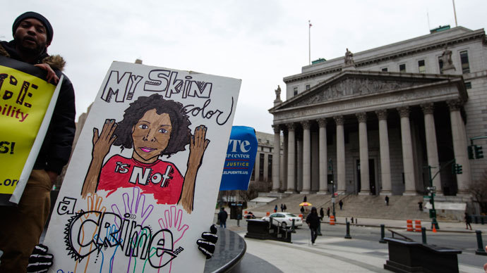 Demonstrators hold signs protesting the New York Police Department's "stop and frisk" crime-fighting tactic outside of Manhattan Federal Court in New York, March 18, 2013.(Reuters / Lucas Jackson)