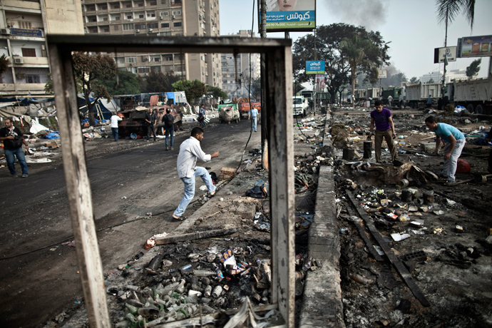 Egyptians search through the debris at Rabaa al-Adawiya square in Cairo on August 15, 2013, following a crackdown on the protest camps of supporters of the Egypt's ousted Islamist leader Mohamed Morsi the previous day (AFP Photo / Mahmoud Khaled)