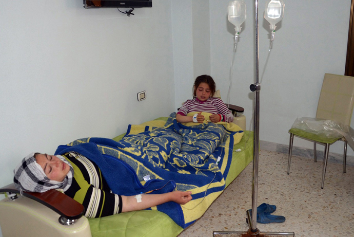 In this image made available by the Syrian News Agency (SANA) on March 19, 2013, a woman and a girl rest on a mattress at a hospital in the Khan al-Assal region in the northern Aleppo province, as Syria's government accused rebel forces of using chemical weapons for the first time (AFP Photo)