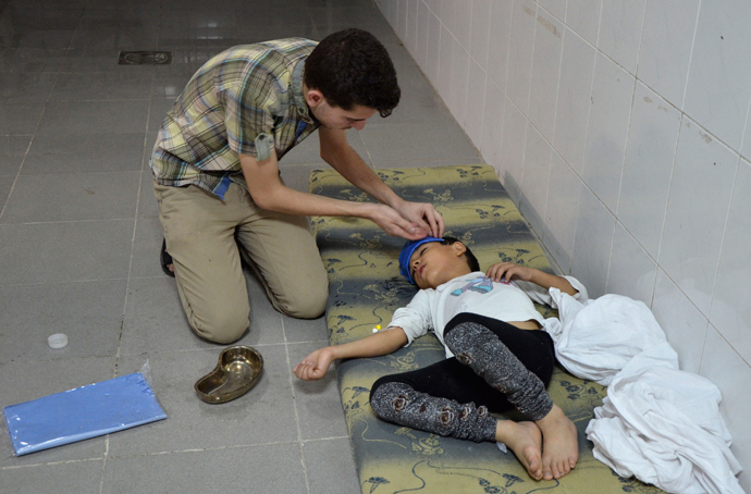 A boy, affected by what activists say was a gas attack, is treated at a medical center in the Damascus suburbs of Saqba, August 21, 2013 (Reuters / Bassam Khabieh)