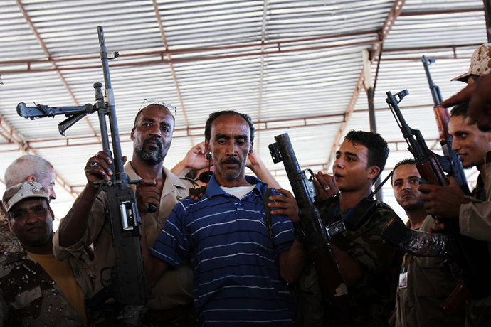 Libyans queue to hand over weapons and ammunition to the military during a ceremony at Freedom Square in the eastern city of Benghazi on September 29, 2012. (AFP Photo / Abdullah Doma)