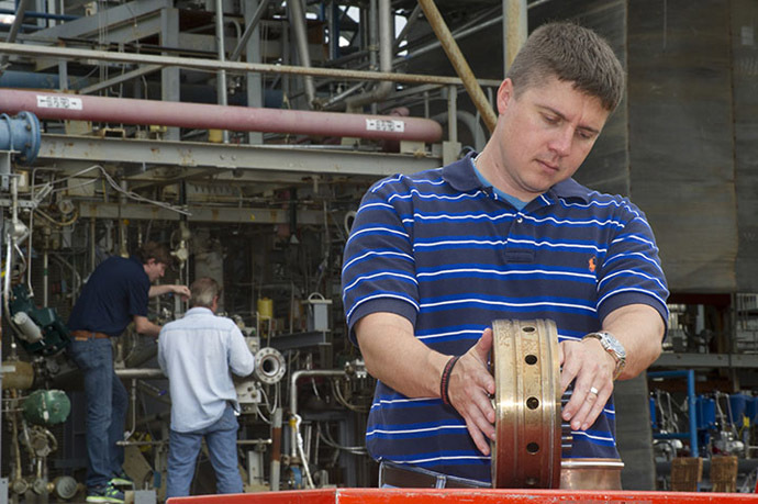 Propulsion systems engineer Greg Barnett prepares a rocket injector for a hot fire test at NASA's Marshall Space Flight Center. (NASA/MSFC/Emmett Given)