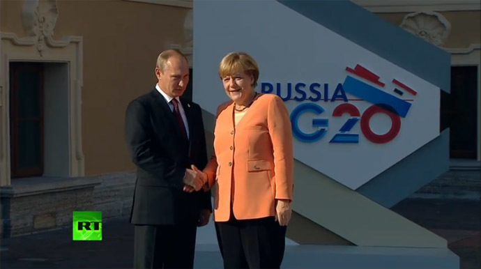 Putin greets Merkel.
