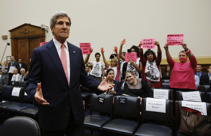 U.S. Secretary of State John Kerry reacts as he waits for U.S. Secretary of Defense Chuck Hagel and General Martin Dempsey, chairman of the Joint Chiefs of Staff, to arrive as he appears at a U.S. House Foreign Affairs Committee hearing on Syria on Capitol Hill in Washington, September 4, 2013. (Reuters/Jason Reed)