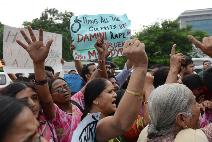 Indian women shout slogans outside the District court in Saket as they call for the death penalty the four men convicted of rape and murder in New Delhi on September 13, 2013. (AFP Photo/Roberto Schmidt)