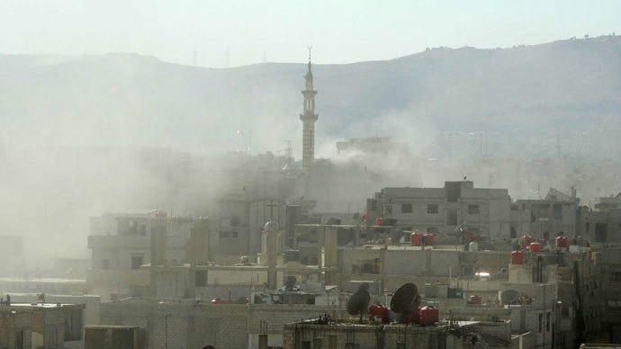 Smoke above buildings following what Syrian rebels claim to be a toxic gas attack by pro-government forces in eastern Ghouta, on the outskirts of Damascus on August 21, 2013.(AFP Photo / Shaam News Network )