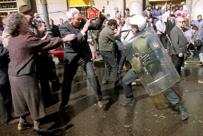 A pro-communist supporter is attacked by an officer of the special militia unit during a demonstration 01 May 1993 in Moscow. (AFP Photo/Michael Evstafiev)