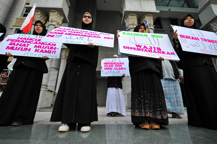Protestors display placards reading "Allah word only can be used by Muslims" during a demonstration at the court of appeal in Putrajaya, outside Kuala Lumpur on October 14, 2013. (AFP Photo/Mohd Rasfan)