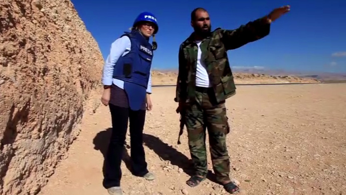 RTâs Maria Finoshina (L) interviews Free Syrian Army Fighter, Abu al Hasan, outside the village of Maaloula. (Still from RT video)