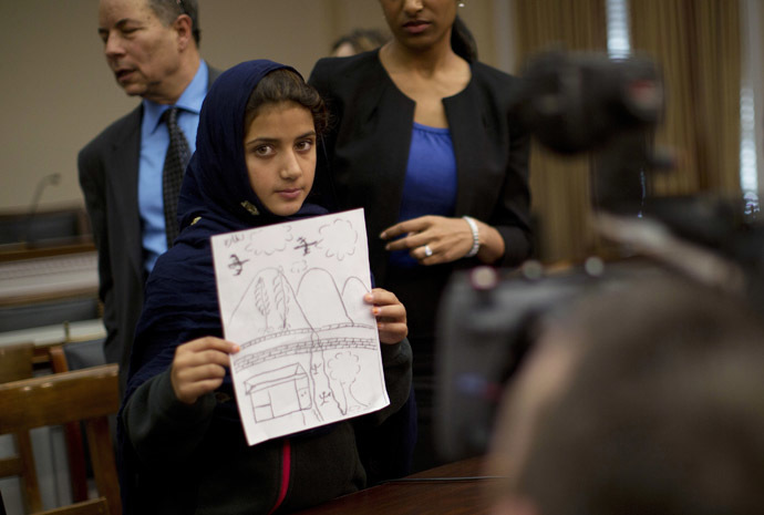 Nabila Rehman, 9, holds up a picture she drew depicting the U.S. drone strike on her Pakistan village which killed her grandmother Mammana Bibi, at a news conference on Capitol Hill in Washington October 29, 2013. (Reuters/Jason Reed)