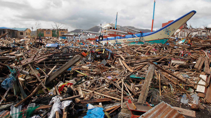 A fishing boat which slammed into damaged houses lie atop debris after super Typhoon Haiyan battered Tacloban city, central Philippines November 10, 2013. (Reuters / Romeo Ranoco)