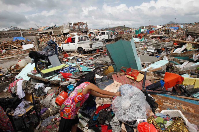 A woman dries her clothes near thousands of damaged houses after super Typhoon Haiyan battered Tacloban city, central Philippines November 10, 2013.(Reuters / Romeo Ranoco)