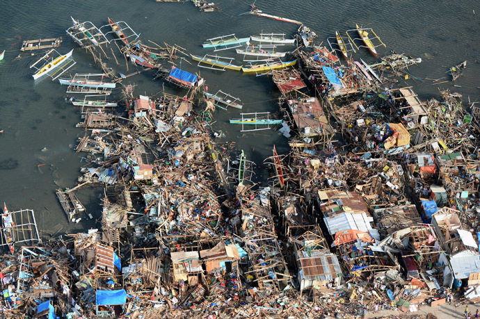 This aerial photo shows destroyed houses along the water in the town of Guiuan in Eastern Samar province in the central Philippines on November 11, 2013 only days after Super Typhoon Haiyan devastated the town on November 8. (AFP Photo/Ted Aljibe)