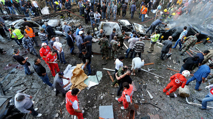 Soldiers, policemen and medical personnel gather at the site of explosions near the Iranian embassy in Beirut November 19, 2013. (Reuters / Hasan Shaaban)