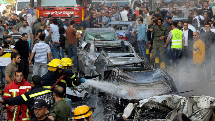 Civil Defence personnel extinguish a fire on cars at the site of explosions near the Iranian embassy in Beirut November 19, 2013.(Reuters / Mahmoud Kheir)