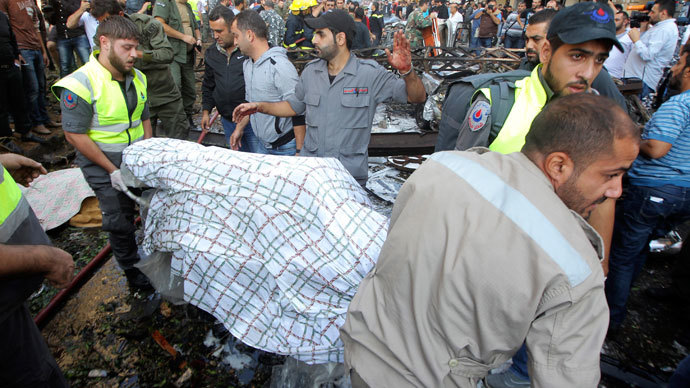 Civil Defence personnel transport a body at the site of explosions near the Iranian embassy in Beirut November 19, 2013.(Reuters / Mahmoud Kheir)