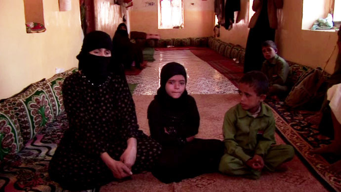 Um Salim al-Qawli, the mother of 20-year old Salim, sits with Aliâs three children. They grieve for her son and their father. Screenshot from RT video