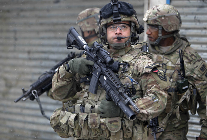 U.S. troops with the International Security Assistance Force (ISAF) keep watch at the site of a suicide attack in Kabul, February 27, 2013. (Reuters/Omar Sobhani)