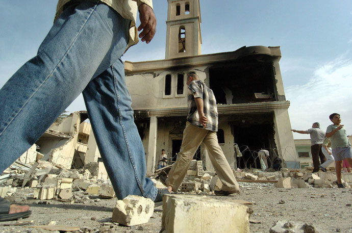 Iraqi people gather outside of a destroyed church following an explosion in Baghdad.(AFP Photo / Jewel Samad)
