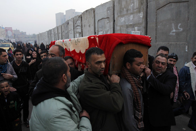 Mourners carry the coffin of a victim killed by a bomb attack in Baghdad's Sadriya district, November 26, 2013. (Reuters/Thaier Al-Sudani)