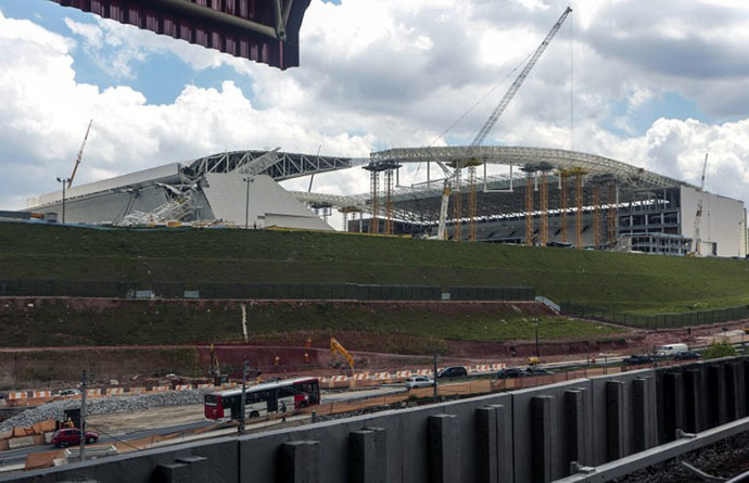 General view of damages (L) at the Arena de Sao Paulo --Itaquerao do Corinthians-- stadium, still under construction, after a crane fell across part of the metallic structure, on November 27, 2013 in Sao Paulo. (AFP Photo / Miguel Schincariol)