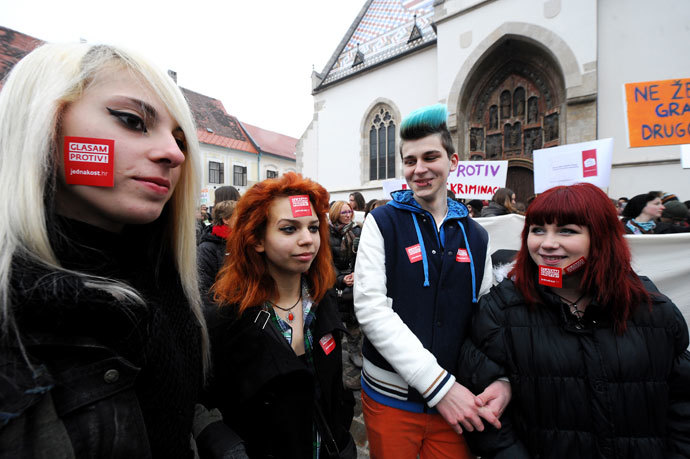 Croatian gay rights supporters sporting stickers reading "Vote against" take part in a protest outside the parliament building in Saint Marko Square in Zagreb on November 30, 2013 .(AFP Photo / STR)