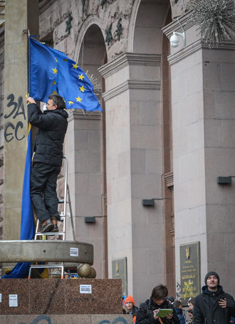 Supporter of Ukraine's European integration hangs a EU flag on a building of city Rada in Kiev.(RIA Novosti / Alexey Kudenko)