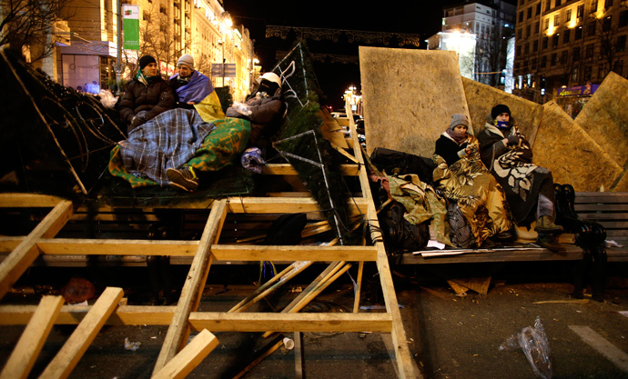Protesters supporting EU integration rest on a barricade at Independence Square in Kiev December 2, 2013. (Reuters / Stoyan Nenov)