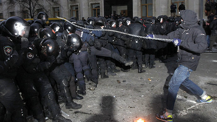 A man swings a chain as protesters try to break through police lines near the presidential administration building during a rally held by supporters of EU integration in Kiev, December 1, 2013. (Reuters / Vasily Fedosenko)