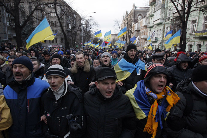 Protestors wave flags and shout slogans during a demonstration in support of EU integration in Kiev December 3, 2013. (Reuters/Gleb Garanich)