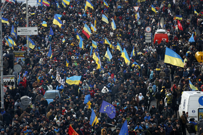 Protesters wave flags as they make their way to Independence Square in Kiev December 3, 2013. (Reuters/Stoyan Nenov)