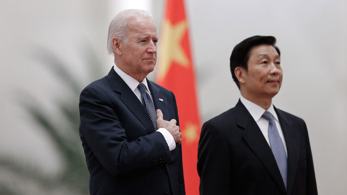 Chinese Vice President Li Yuanchao (R) and US Vice President Joe Biden (L) listen to their national anthems during a welcoming ceremony inside the Great Hall of the People in Beijing on December 4, 2013.(AFP Photo / Lintao Zhang)