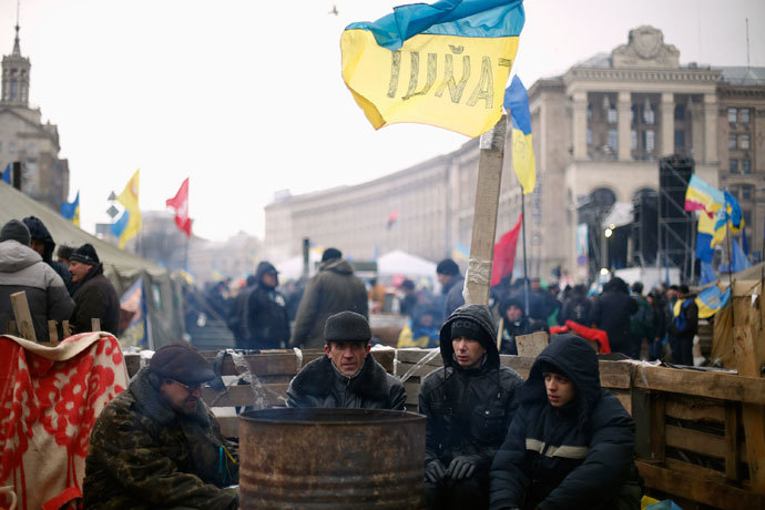 Protesters warm up near a barricade at Independence Square in Kiev December 7, 2013. (Reuters / Stoyan Nenov)
