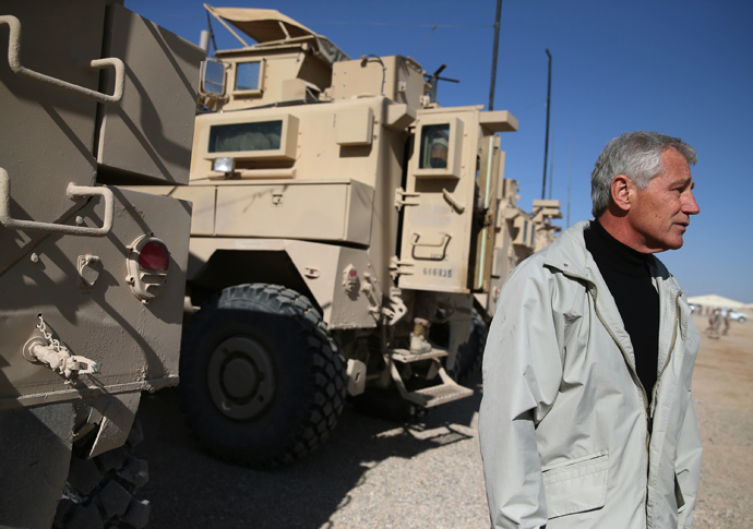 U.S. Secretary of Defense Chuck Hagel stands next to MRAP vehicles after speaking to US troops, on December 8, 2013 in Kandahar. (AFP Photo / Pool Mark Wilson) 