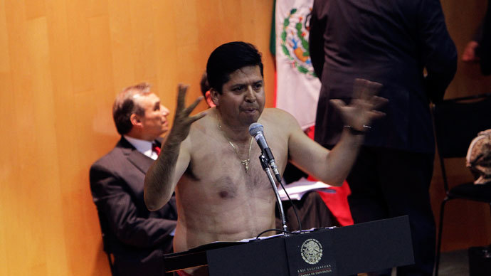 Antonio Garcia of the Party of the Democratic Revolution (PRD) addresses the audience after stripping down to his underwear during his speech on the podium during the overnight debate to symbolize the stripping of Mexico's oil wealth in Mexico City December 12, 2013.(Reuters / Stringer)